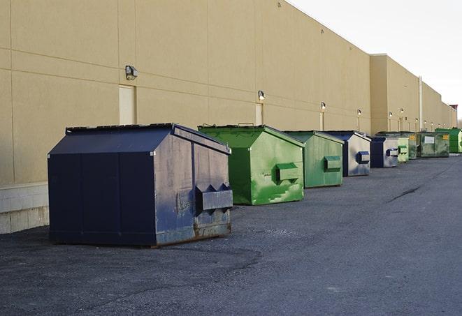 large garbage containers clustered on a construction lot in Britton